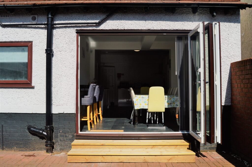 Positive Futures Home – Dining area with patio doors